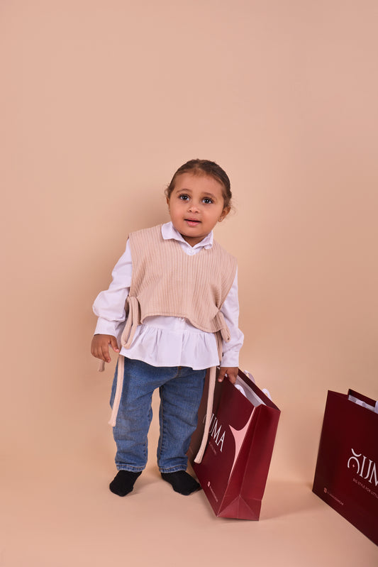 beige knit vest and white shirt